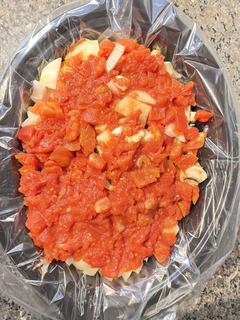 top view of ingredients in crock pot for Spaghetti Meat Sauce