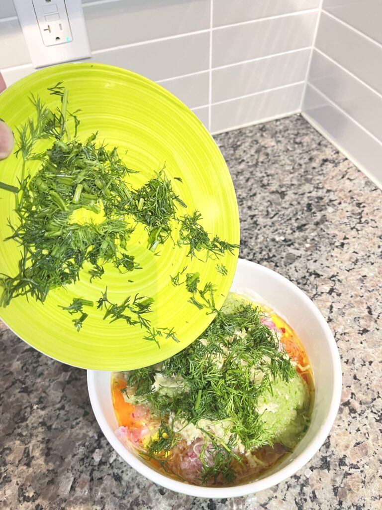 adding dill to Radish Tzatziki Dip