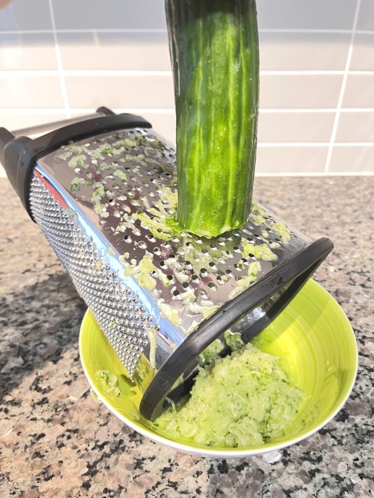 shredding cucumber for Radish Tzatziki Dip