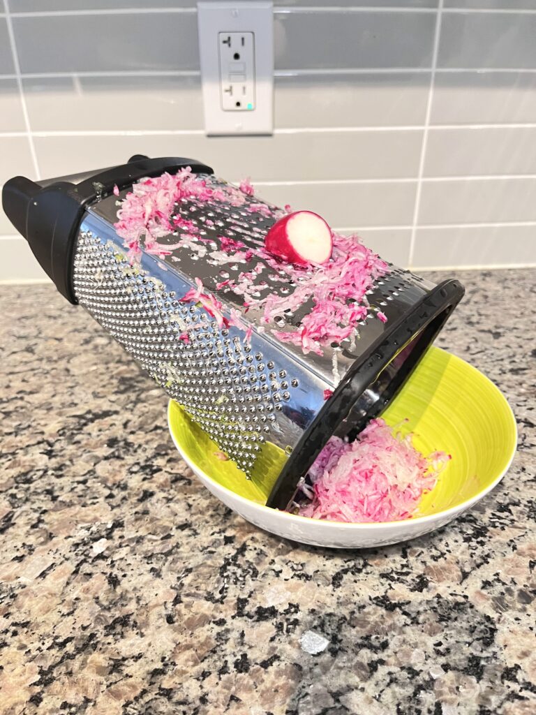 shredding radish for Radish Tzatziki Dip