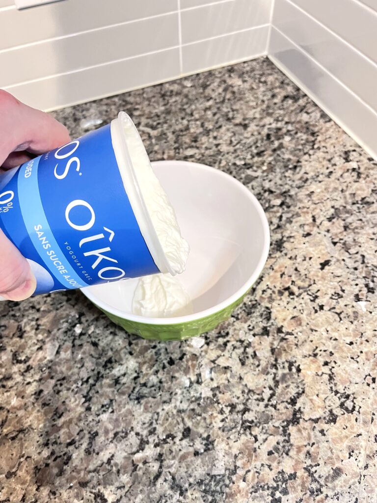 pouring yogurt to the bowl for Radish Tzatziki Dip